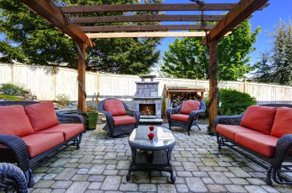 patios with red couches and a centrepiece designed by Caloundra Landscaping